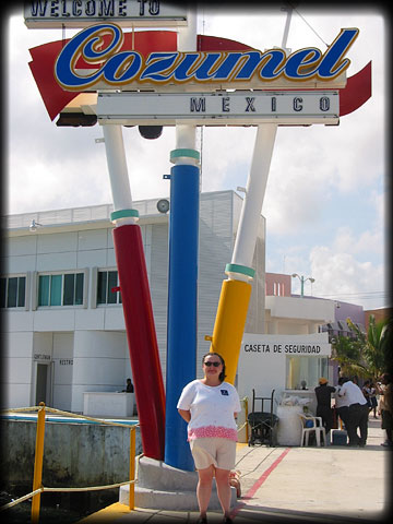 Becky Under Cozumel Welcome Sign