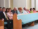 Family in pews immediately after wedding