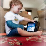 Enjoying one of his Duck Duck Moose games on the iPad