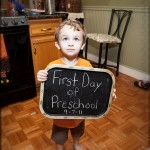 Holding the sign Mommy made for him on his first day of three-year pre-kindergarten