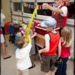 Clown entertains Max & friends with balloon animals & toys