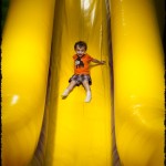 Sliding down the big slide at Monkey Joe’s