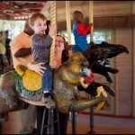 On the merry-go-round with Mama at Zoo Atlanta