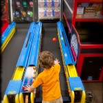 Playing skeeball overhanded